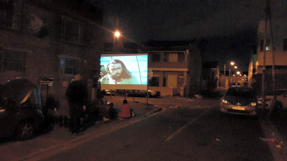 Showing Jesus Film on pavement in bad drug area in Woodstock Cape Town
